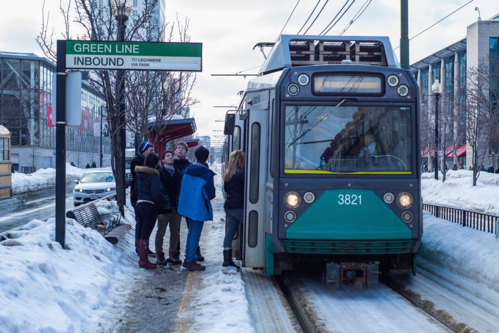 Riders board a Green Line train at Northeastern University Station.