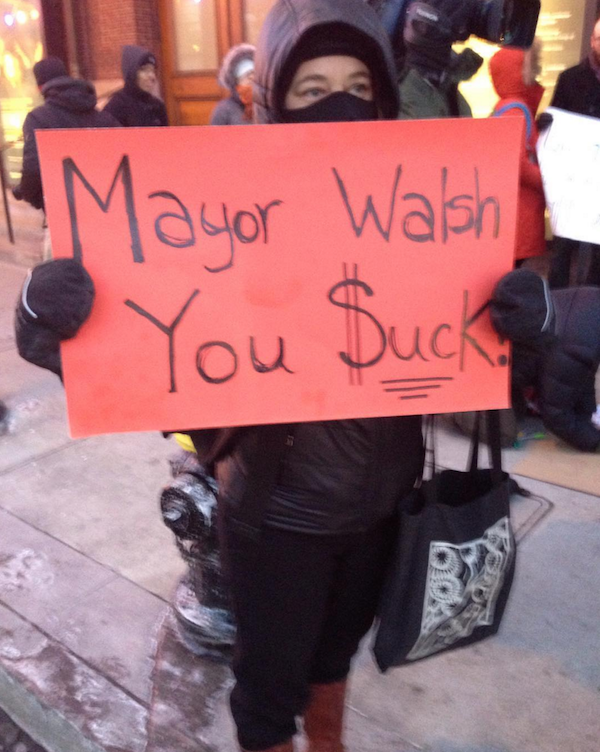 Danielle Diers, a parent of a Boston Public Schools student, shows her opinion of Mayor Martin Walsh outside the State of the City address at Symphony Hall on Tuesday, Jan. 19.