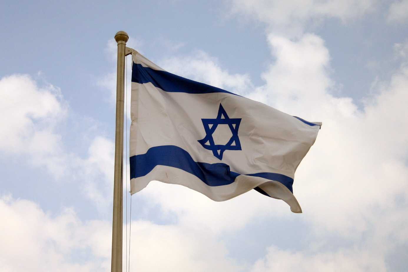 Israeli Flag waving against blue skiy