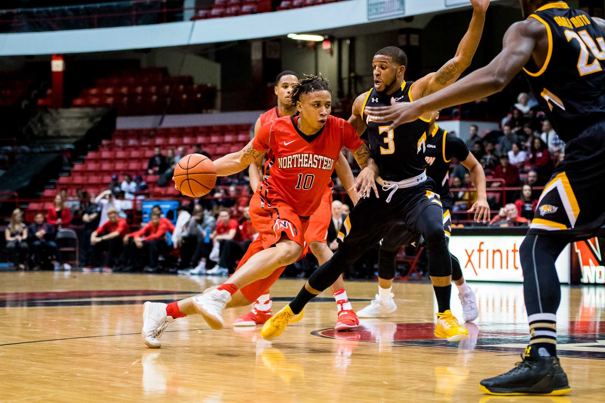 Senior T.J. Williams (10) charges ahead past Towson's Deshaun Morman (3) towards the basket.