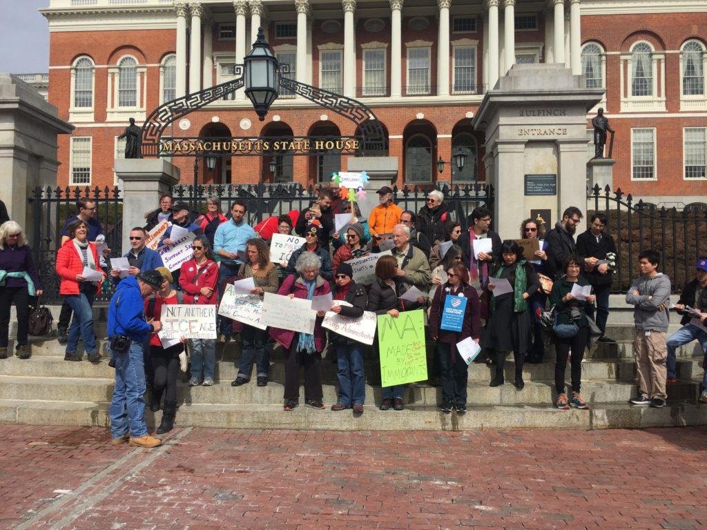 Protestors gather in front of the state house to urge Gov. Baker to make Massachusetts a sanctuary state for undocumented immigrants. / File photo by Ryan Grewal