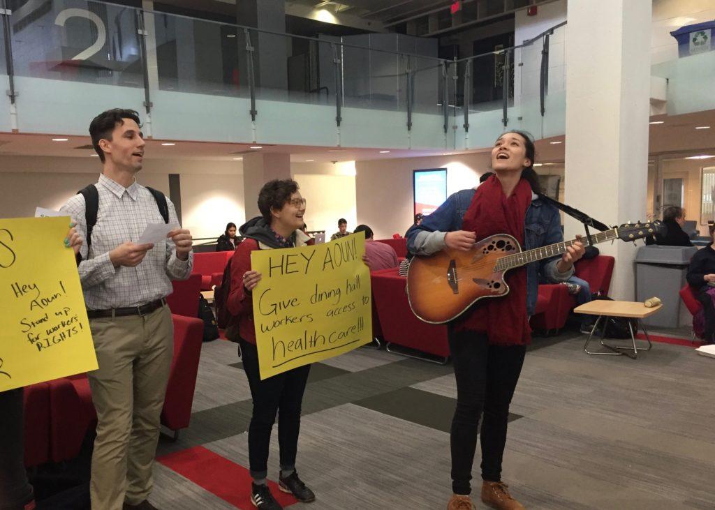 Students sing to advocate for higher wages for dining hall workers