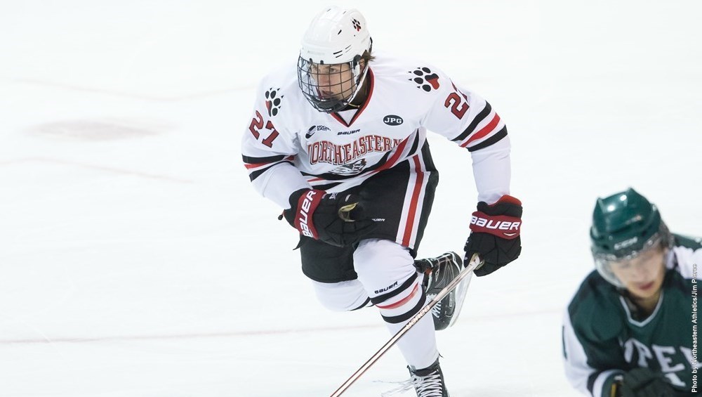 First-year+forward+Bobby+Hampton+drives+for+the+puck+during+an+earlier+season+meeting+against+Rochester.+Photo+courtesy+Jim+Pierce+%2F+Northeastern+Athletics