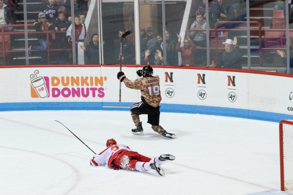 Third-year forward Lincoln Griffin celebrates his goal against Boston University as a defeated Terrier looks on. Photo by Albert Tamura.
