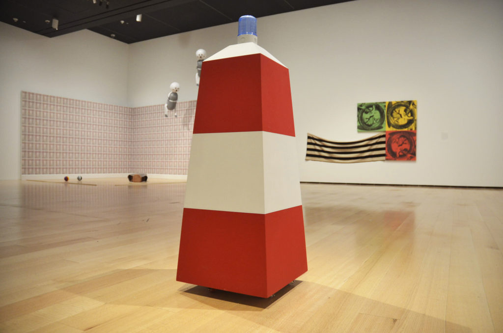 Fire Cone, wood, acrylic, light fixture and caster wheels, is also about surveillance and censorship. Its blue light and red stripes signal a nationalist authority in a state of emergency. / Photo by Samuel Kim. 