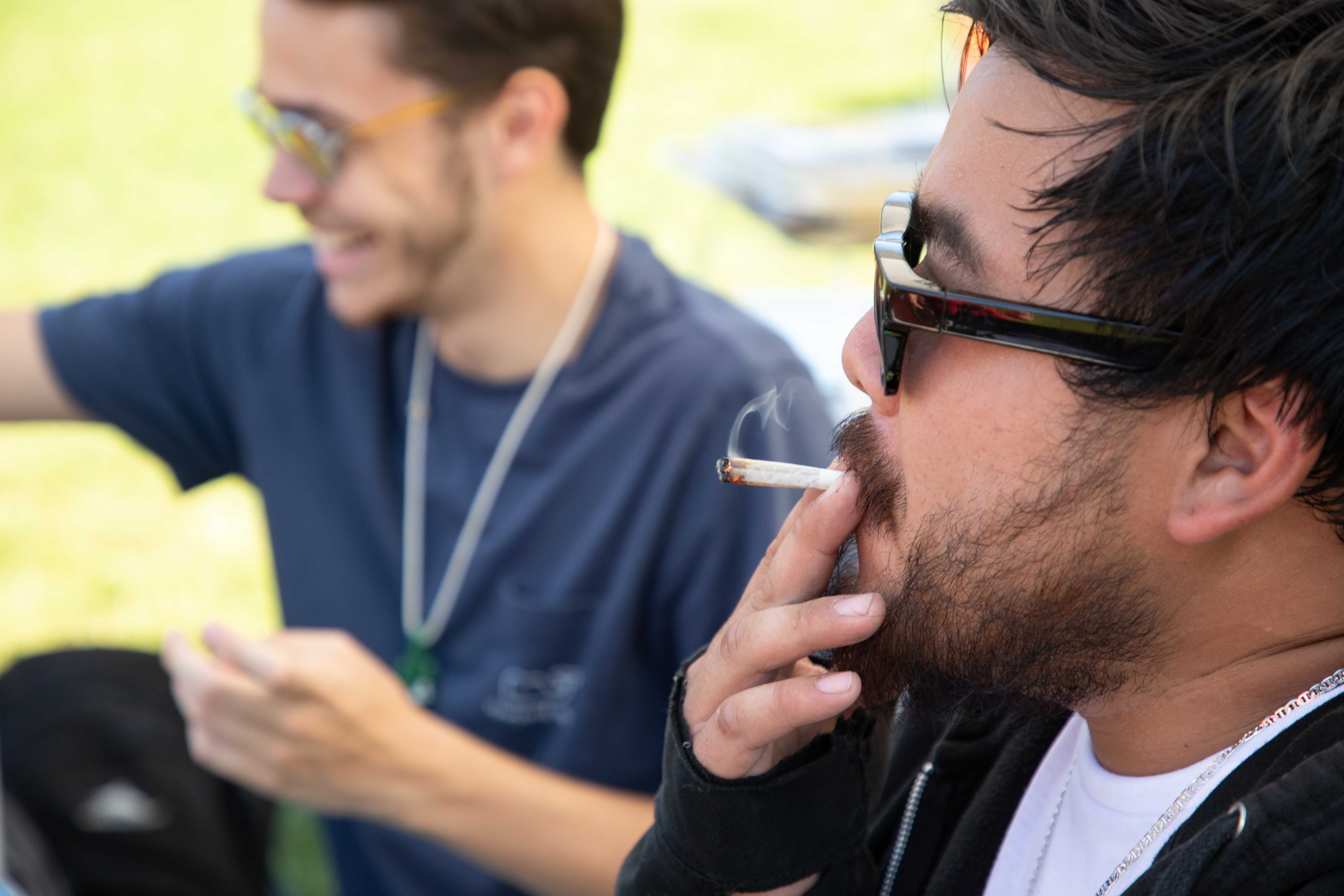 Ashton Chan, at right, of Waltham smokes with Michael Gordon of Framingham Sunday at the Boston Freedom Rally for legalized marijuana Sunday, Sept. 16 on Boston Common. / Photo by Riley Robinson