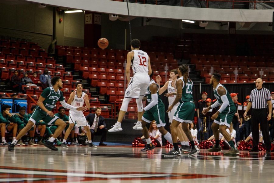 Redshirt junior guard Justin Roland fires a pass towards redshirt freshman forward Jason Strong in a prior game against Eastern Michigan. / File photo by Catherine Argyrople.