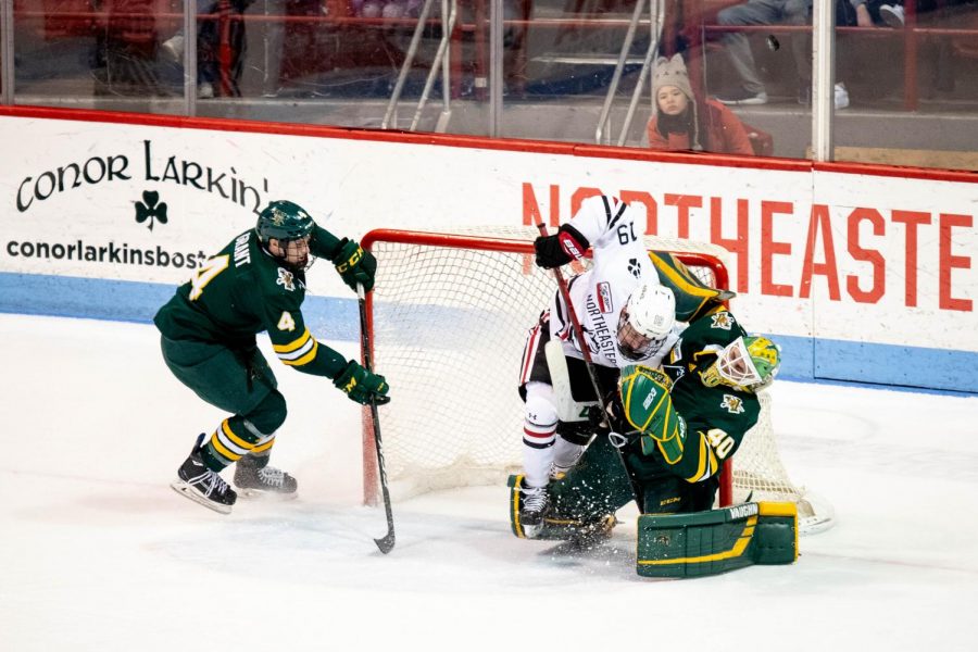 Lincoln Griffin crashes into UVM netminder Stefanos Lekkas, earning a two-minute minor penalty for charging.