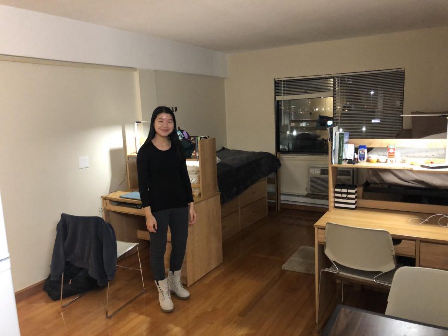 Third-year English and psychology major Crystal Lau stands in her apartment on Commonwealth Avenue.