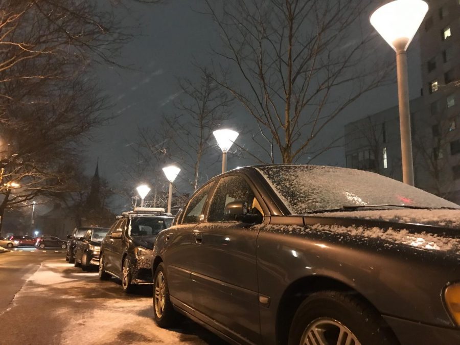 Cars covered in snow sit in between Renaissance Park and International Village.