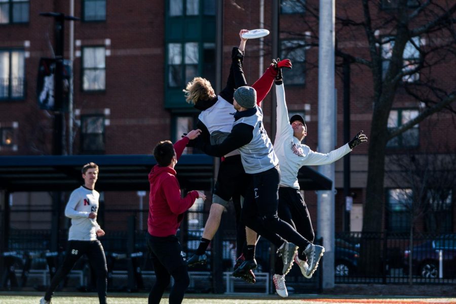 Multiple members of the club ultimate Frisbee team leap for the disc during a practice Feb. 16.
