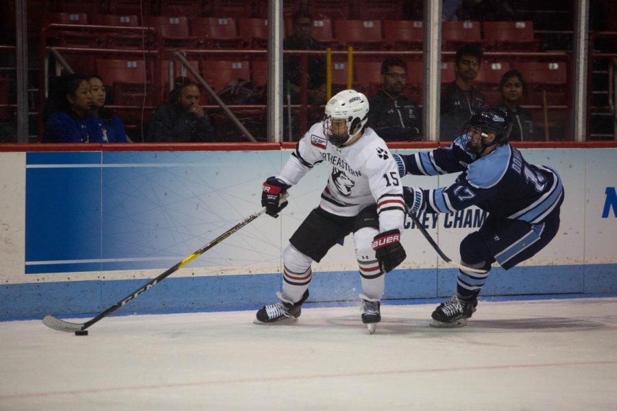 Junior winger Grant Jozefek fends off Maine center Tim Doherty at Matthews Arena last season.