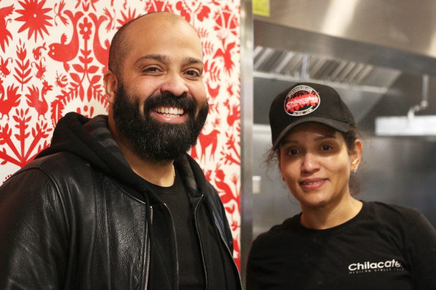Socrates Abreu, who started the Jamaica Plain based Chilacates stands next to his sister-in-law Kaurys Lajara, who runs one of the stores newest branches in Mission Hill. 