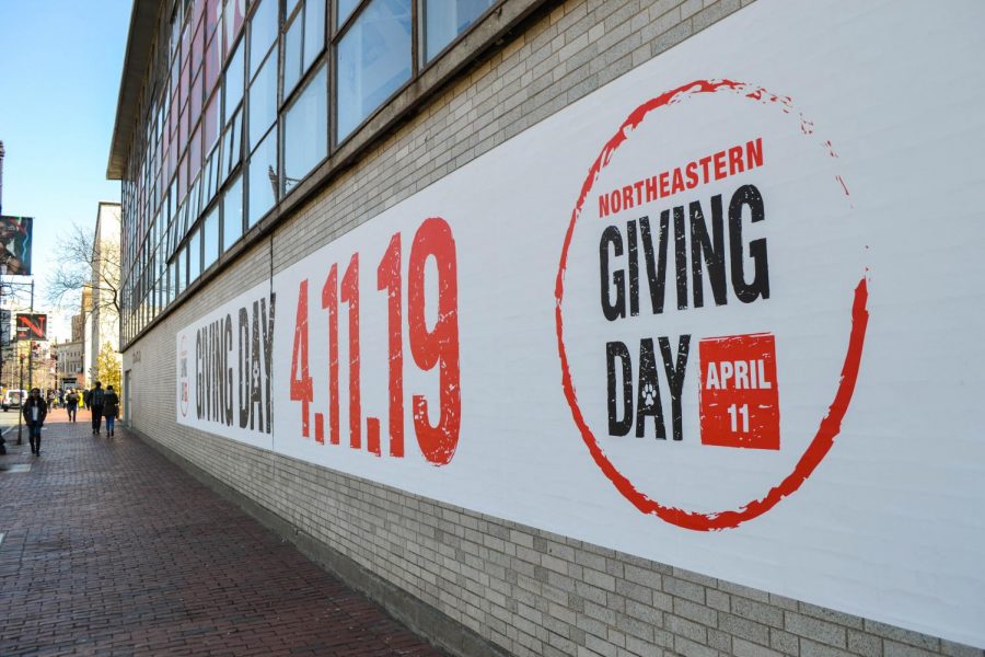 Giving Day promotional materials appear around campus, including this poster on Huntington Avenue.