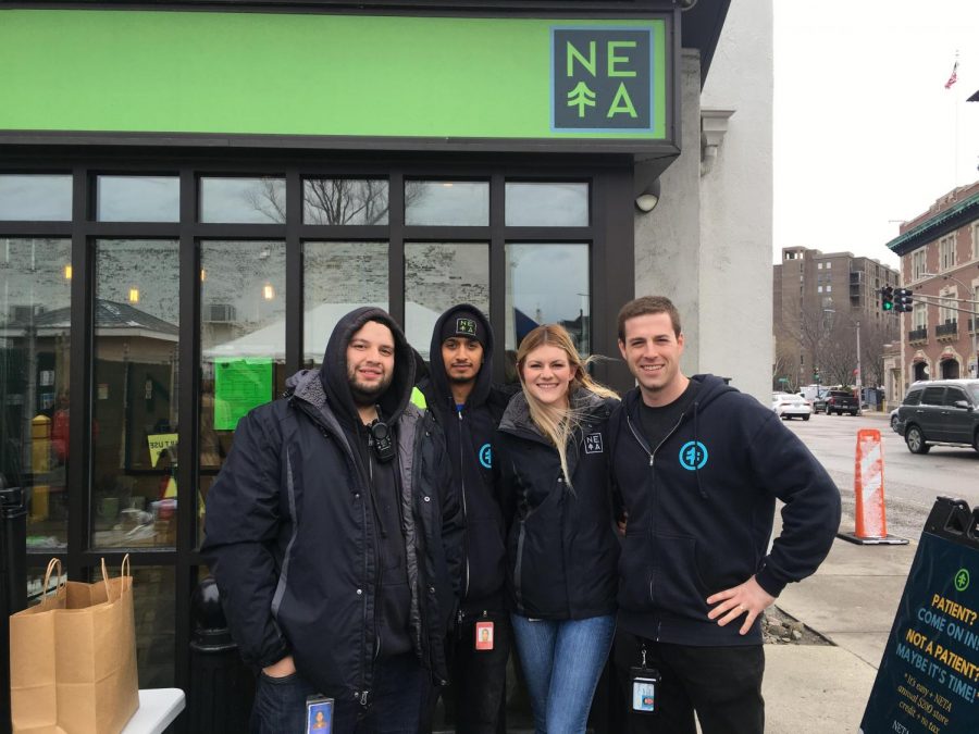 NETA employees stand outside the company's Brookline location, which opened its doors to recreational users Saturday.