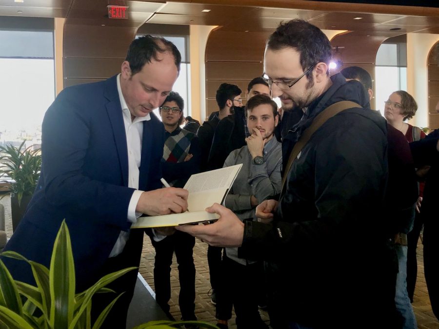 Nate Silver signs a copy of his book after the talk March 27.