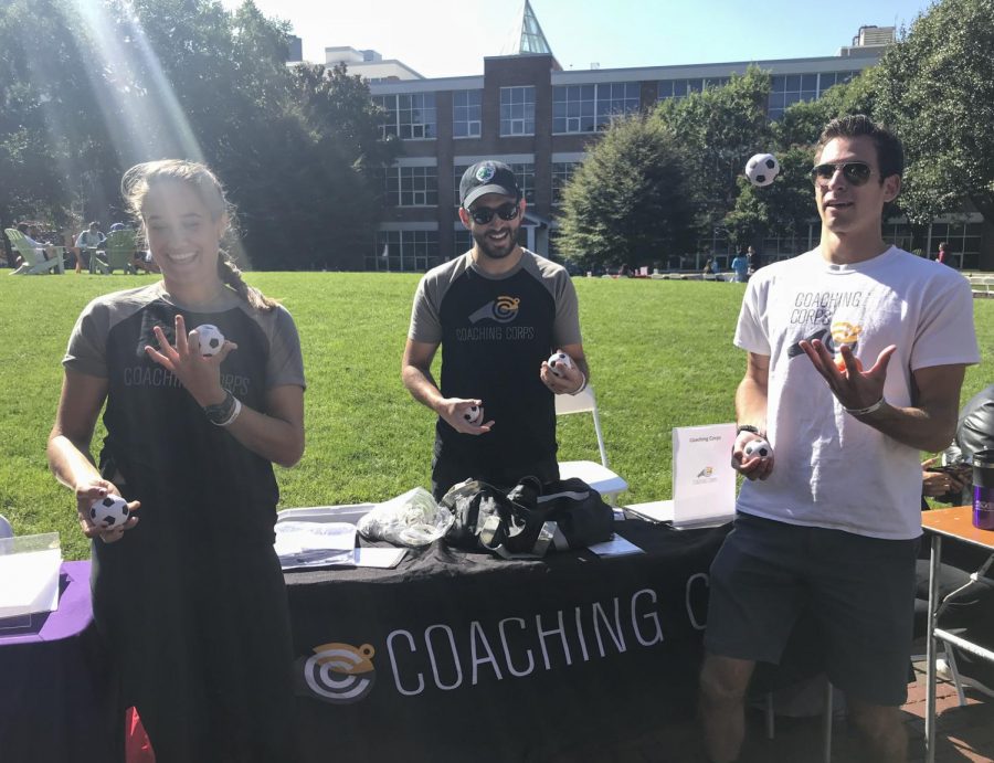 Volunteers from Coaching Corps show off their juggling skills in front of Centennial Common.