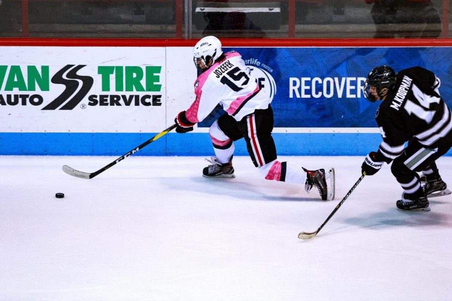 Senior forward Grant Jozefek rushes for the puck in a game against Providence last season.