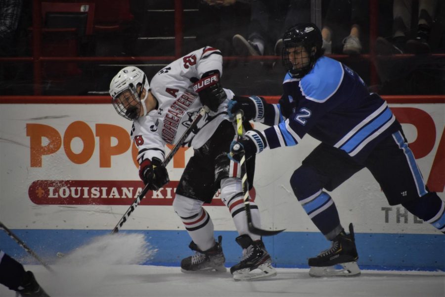 Junior forward Zach Solow passes the puck to a teammate in heavy traffic in todays game versus Maine.