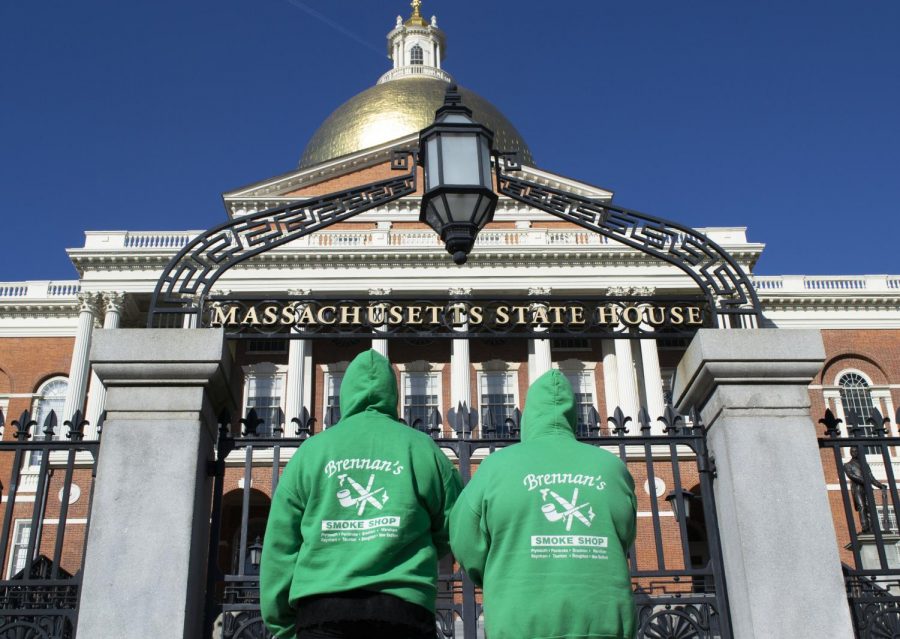 Kristen Brennan and Hannah Magnuson, both employees at Brennans Smoke Shop, stand in front of the Massachusetts State House in protest of the menthol ban.