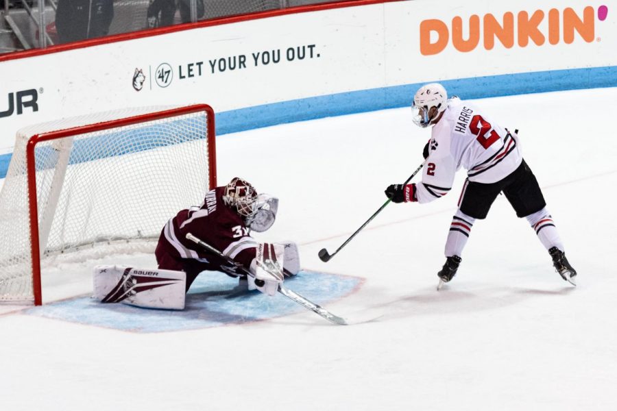 Sophomore defender Jordan Harris attempts to slide the puck past the goaltender in a game against UMass last season.