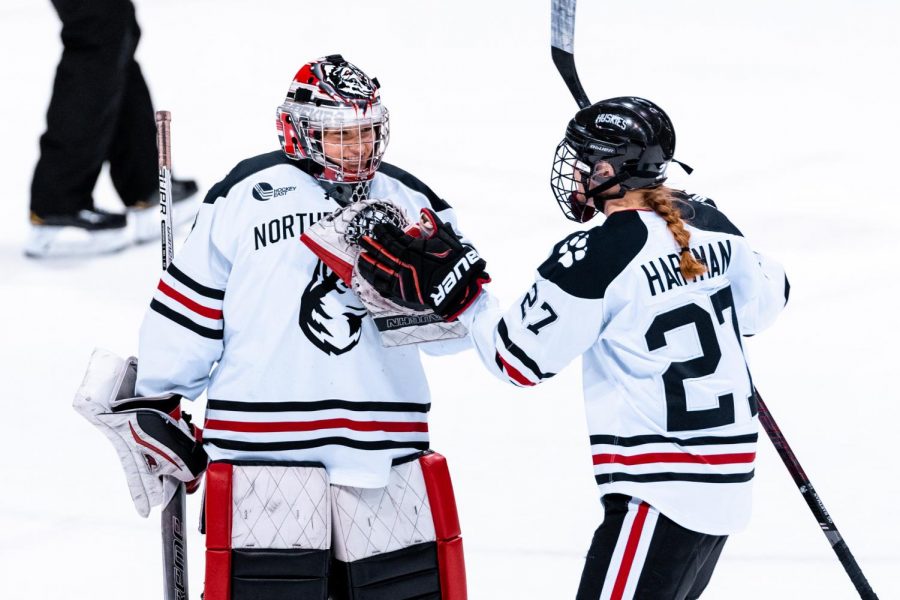 Junior goaltender Aerin Frankel and graduated defender Maddie Hartman greet each other on the ice in a match against Holy Cross last season. 