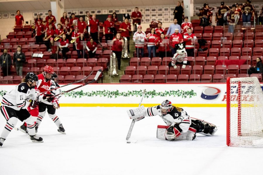 Frankel clears the puck out of the crease during a game against BU last season. 