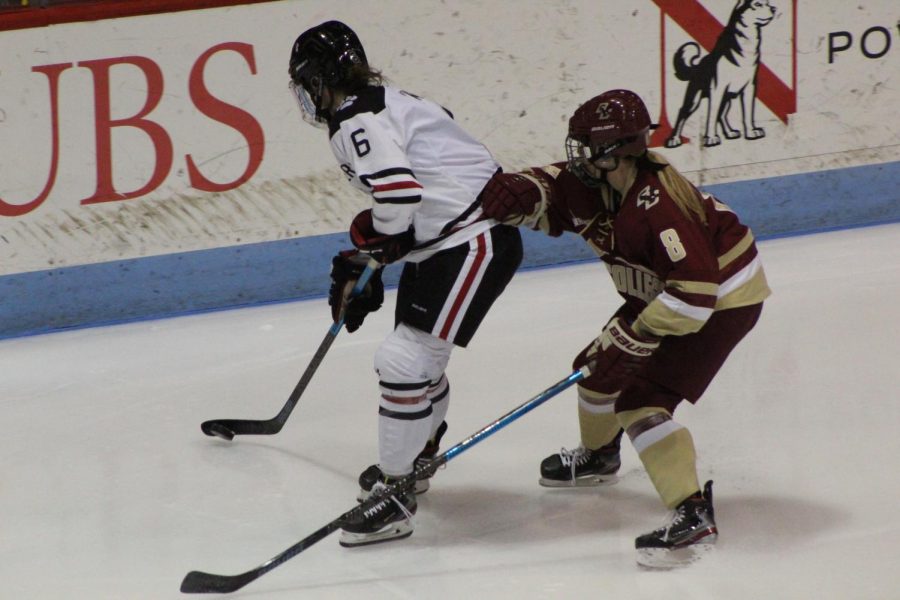 Knoll fights to keep the puck during a game against BC earlier this season.
