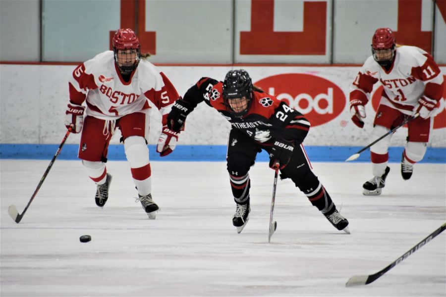 Massachusetts native and freshman forward Kate Holmes charges at the puck. 