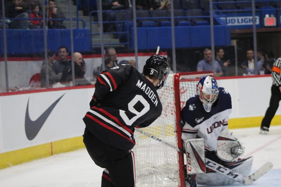 Tyler Madden rips a shot on net, where UConns goaltender waits to squeeze the puck against the pipe.
