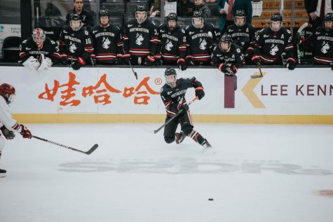 Tyler Madden tracks the puck traveling through the neutral zone in this year's first Beanpot game against Harvard.