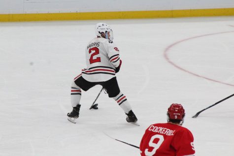 Jordan Harris handles the puck with his eye on the net during the Beanpot final.