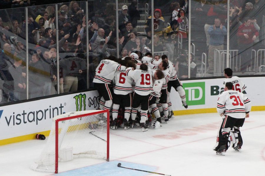 The Huskies, with Harris and Pantano in the middle, celebrate their third straight Beanpot. 