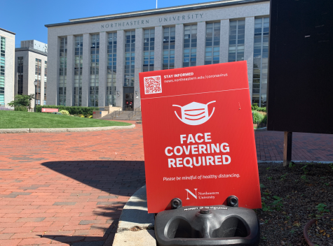 Signs instructing campus visitors to wear a mask are placed around campus.