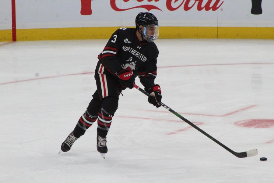 Struble looks to pass in the first game of the 2020 Beanpot against Harvard.