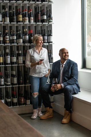 TJ and Hadley Douglas pictured in front of a wine rack at The Urban Grape