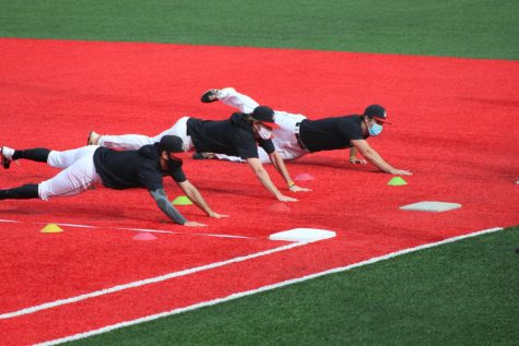 Infielders dive back to first at practice on Parsons Field.