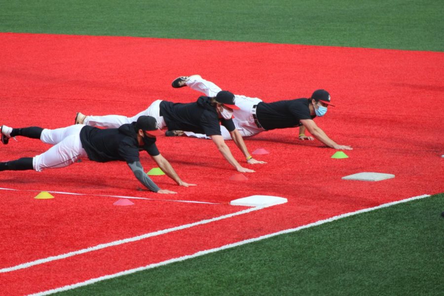 Infielders dive back to first at practice on Parsons Field.