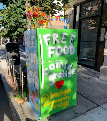 The community fridge in Jamaica Plain sits outside D'Friends Barber Shop.