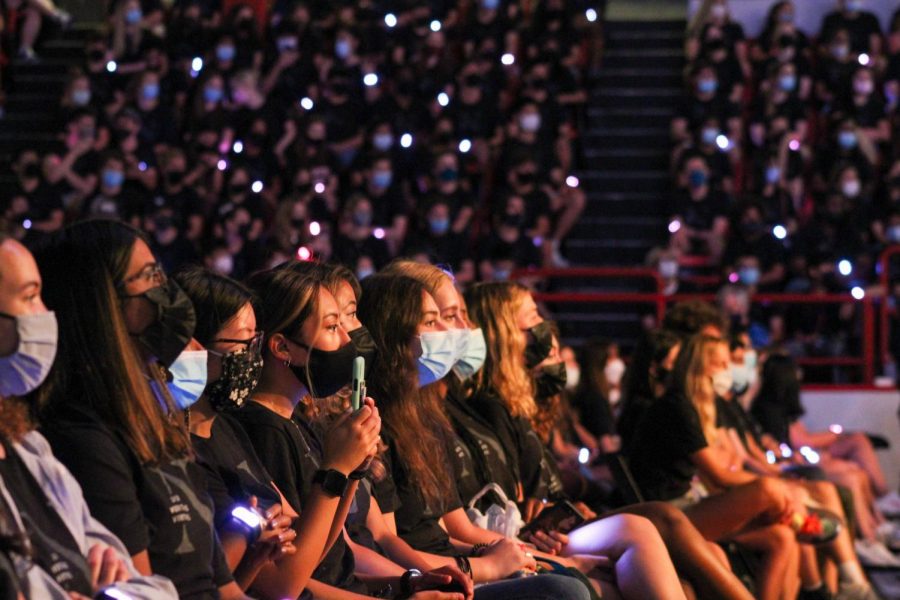 First years, wearing matching Northeastern shirts and coordinating, light-up bracelets, watch the convocation ceremony. At key moments in the ceremony, the bracelets lit up in various colors.