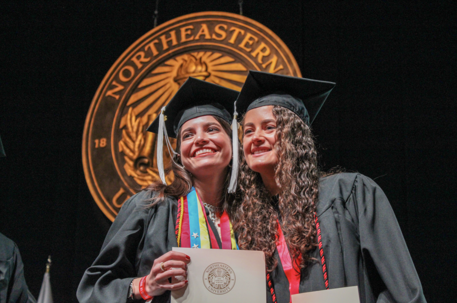 Graduates pose for a picture after receiving their alumni pins. The university will hold its annual commencement ceremony for the class of 2024 at Fenway Park for the fourth year in a row this spring.