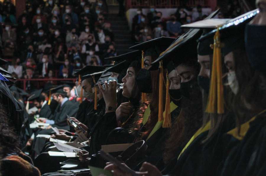 A graduate takes a sip of water during the morning ceremony. 