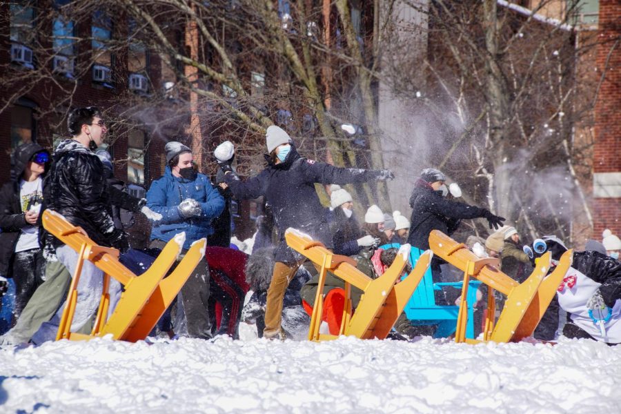 Students throw snowballs at their opponents on the other side of Centennial Common.