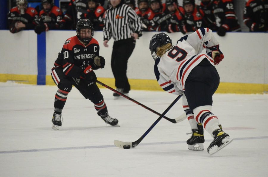 Northeastern captain, Brooke Hobson, faces UConns Natalie Snodgrass on the ice. 