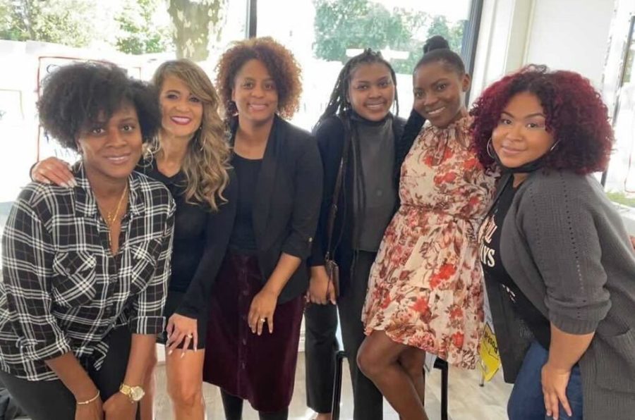 Staff members of The LOFT smile for a group photo. Owner and curl specialist Sharita Payton, third from left, started her personal and professional natural hair journey when she moved to Massachusetts and gave birth to her oldest daughter. Photo credit to Tiffany Hester. 