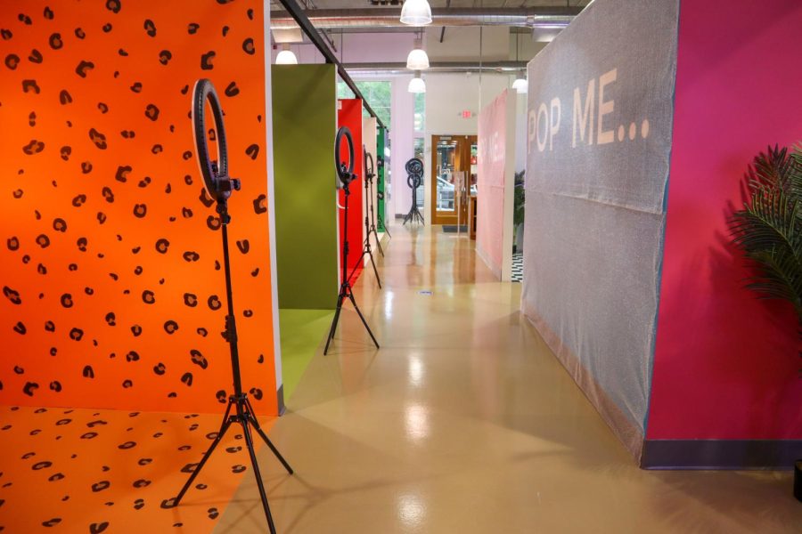 The rooms in Selfie WRLD Boston are small cube-shaped setups with backgrounds, such as a retro cafe scene, a ball pit, a private jet scene, payphones and other colorful walls. Photos courtesy of Selfie Wrld.