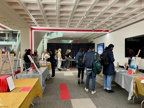 Artists and students gathered in the Curry Student Center March 2 for a bustling and picturesque art show with the aroma of hot chocolate and donuts in the air. 
