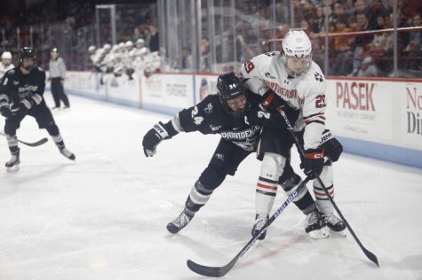 Sophomore forward Justin Hryckowian races to protect the puck from Providence College. 