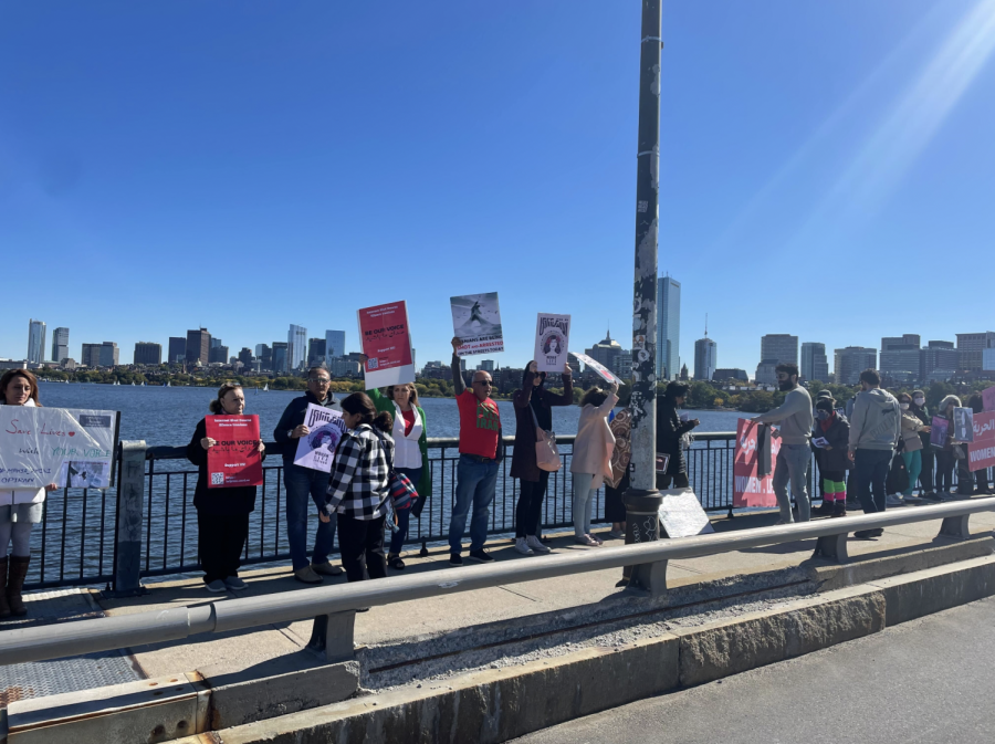 A crowd gathers with signs at the Harvard Bridge Oct. 8, protesting the death of Mahsa Amini. The 22-year-old died in custody of the Iranian morality police Sept. 16.