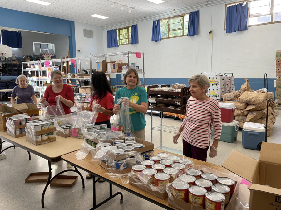 A group of women sort canned food for Roses Bounty food pantry. The organization provides for thousands of Boston residents every month.